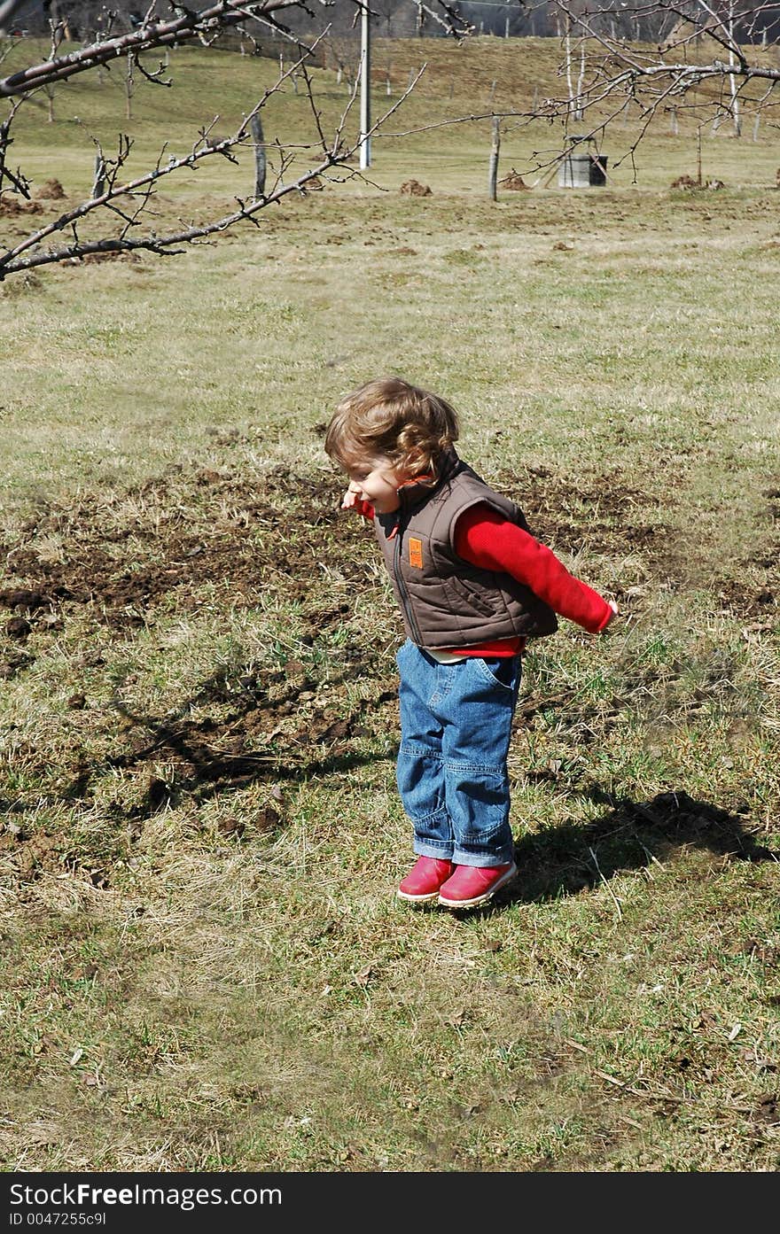 Young girl jumping in an early spring scenery in the country side.