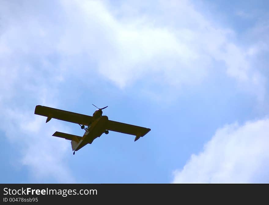 Flying hydroplane on blue sky background. Flying hydroplane on blue sky background