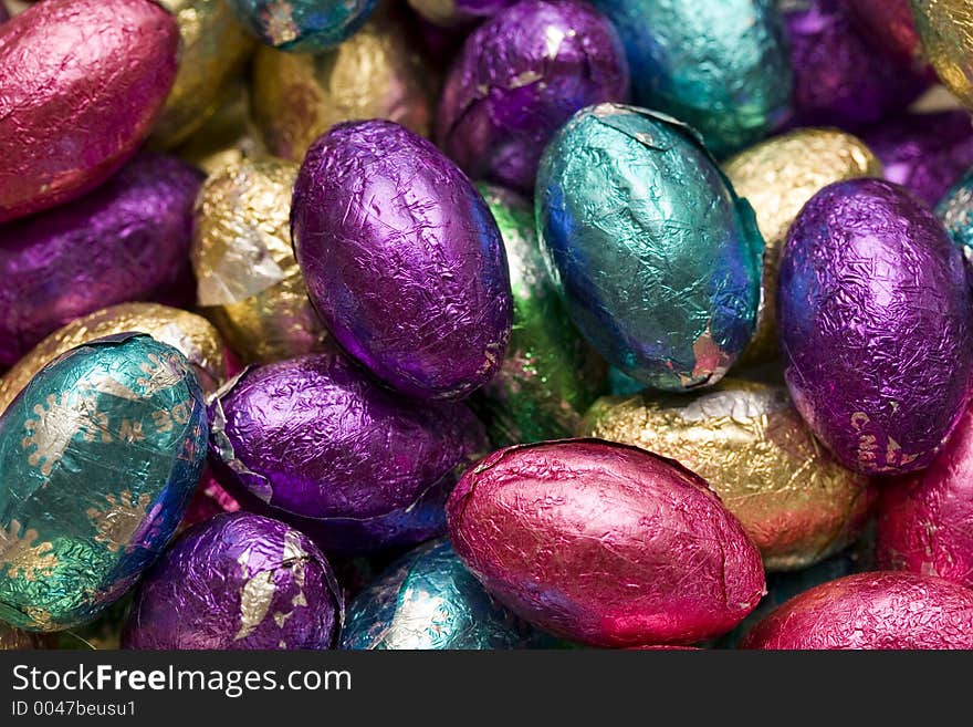 A closeup of a bowl full of foil wrapped chocolate easter eggs