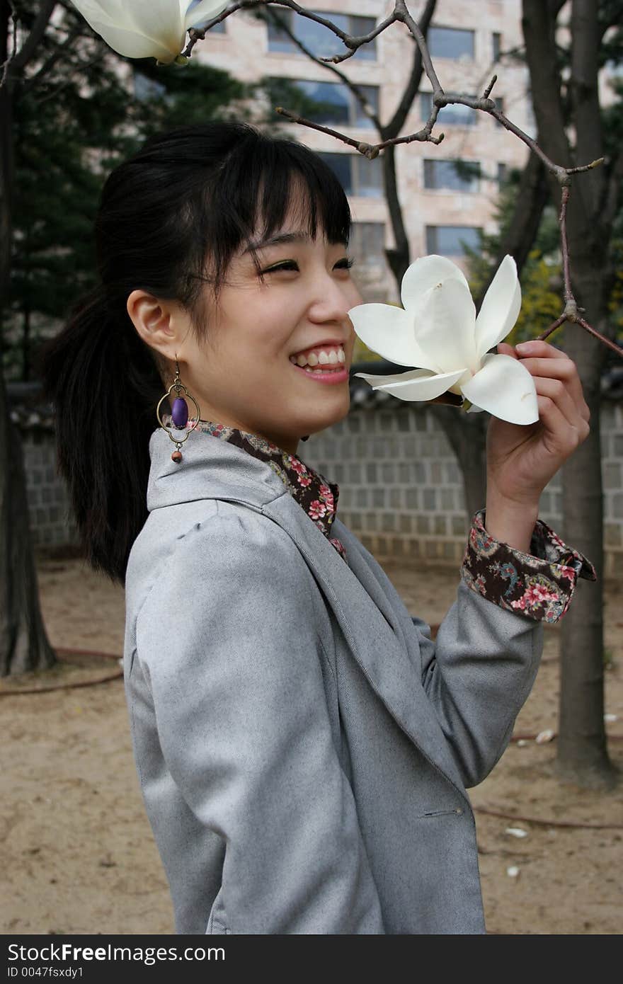 Pretty Korean woman holding a white flower