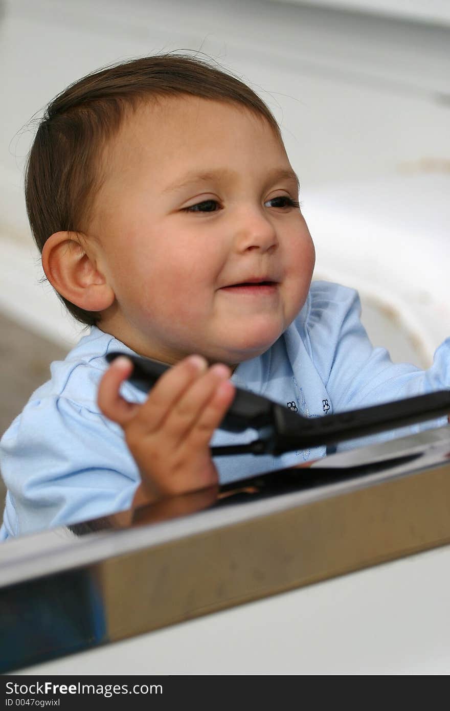 A baby girl with cell phone seems pleased. Shallow depth with primary focus towards her left eye. A baby girl with cell phone seems pleased. Shallow depth with primary focus towards her left eye.