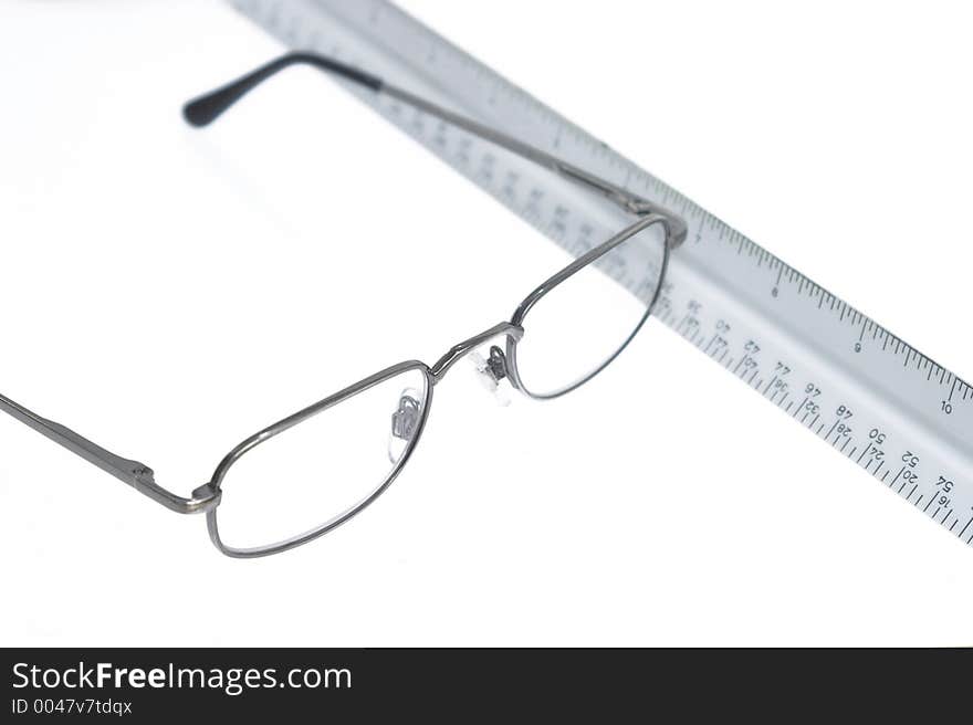 Reading eyeglasses and ruler on table