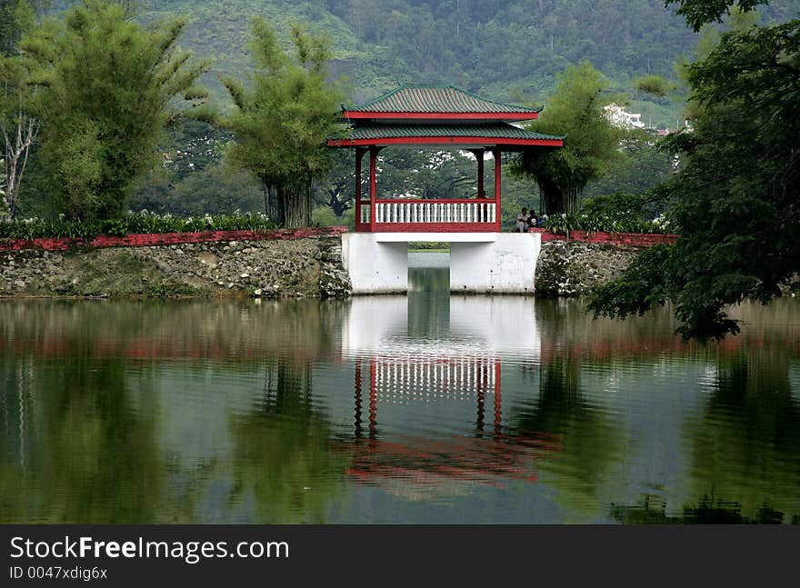 Reflections on the lake of a bridge with Chinese architecture. Reflections on the lake of a bridge with Chinese architecture