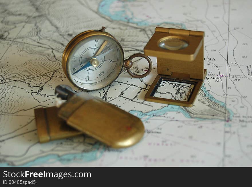 Old compass, magnifier lens and lighter on a map !. Old compass, magnifier lens and lighter on a map !