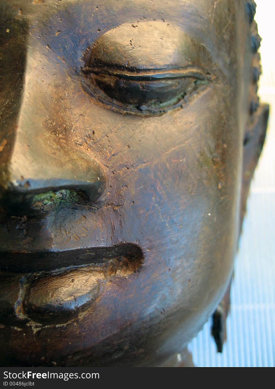 A bronzed sculpture of Buddha’s face. A bronzed sculpture of Buddha’s face.