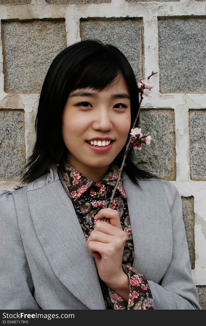 Pretty Korean woman holding flowers. Pretty Korean woman holding flowers