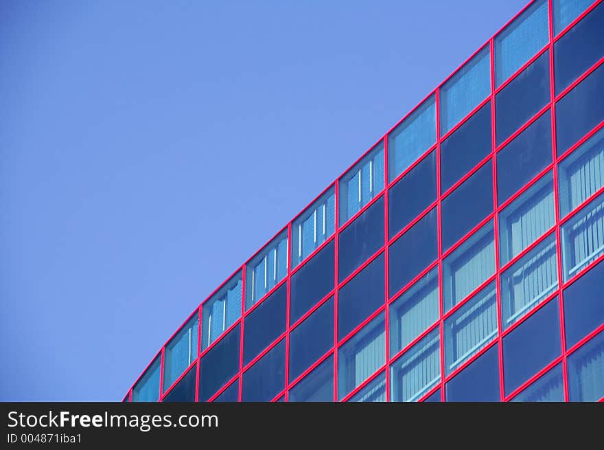 Red windows un the blue building and blue sky. Red windows un the blue building and blue sky.