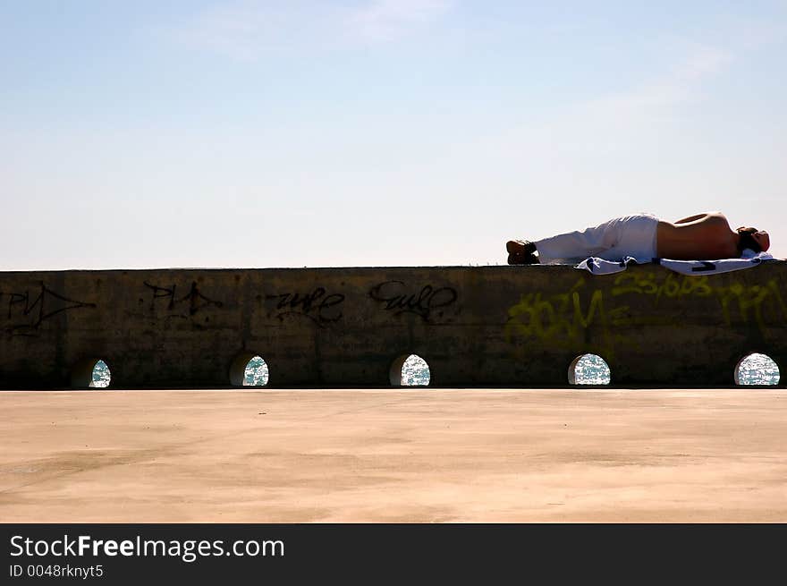 Man laying down resting under the sun. Man laying down resting under the sun