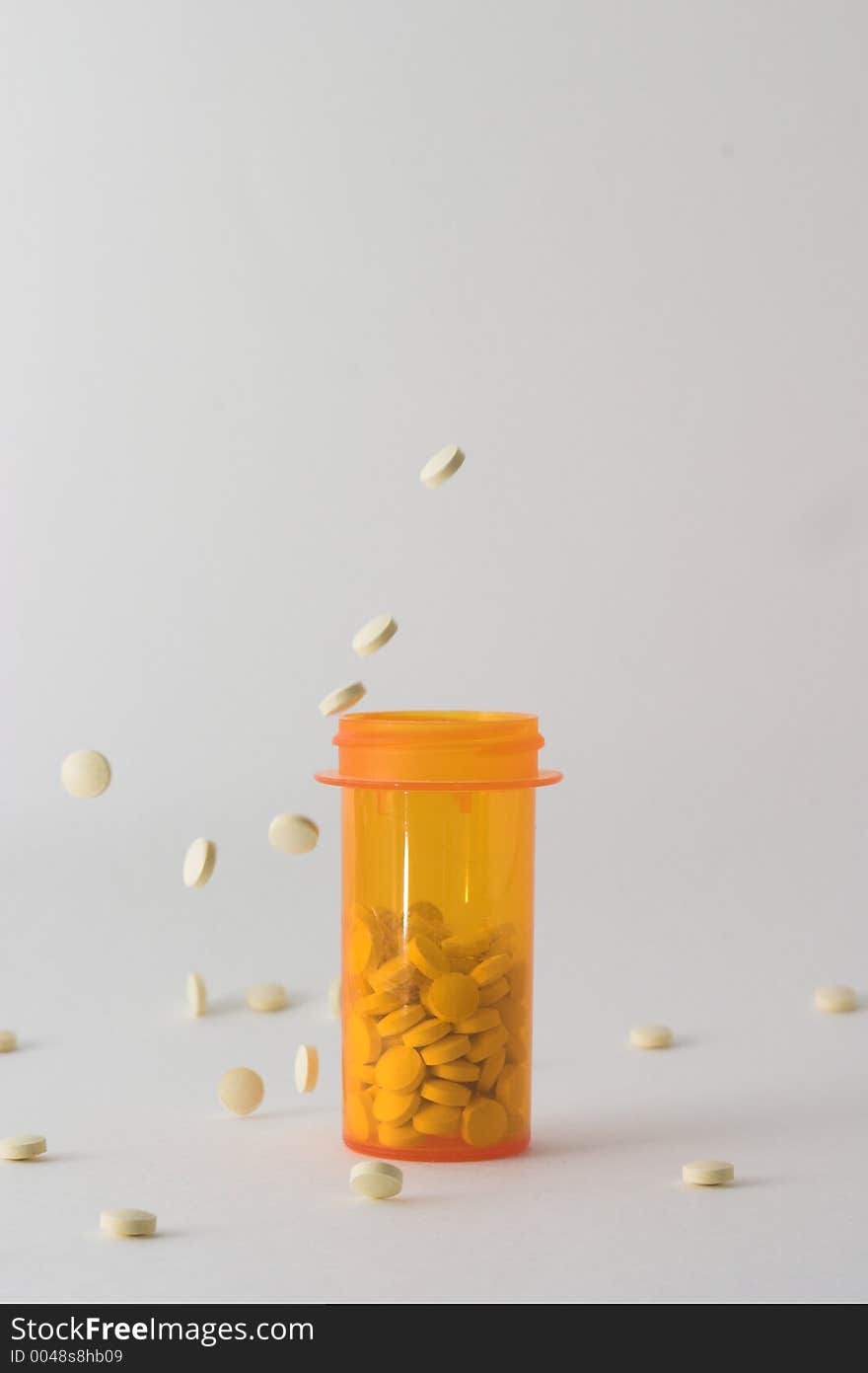 Pills falling into and around medicine bottle version 3