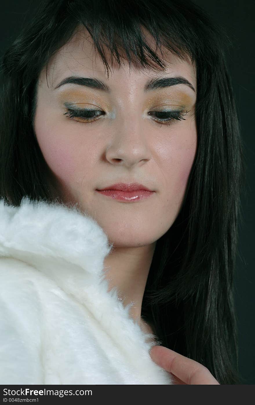 Pretty brunette young woman realising that she is wearing real fur. Pretty brunette young woman realising that she is wearing real fur.