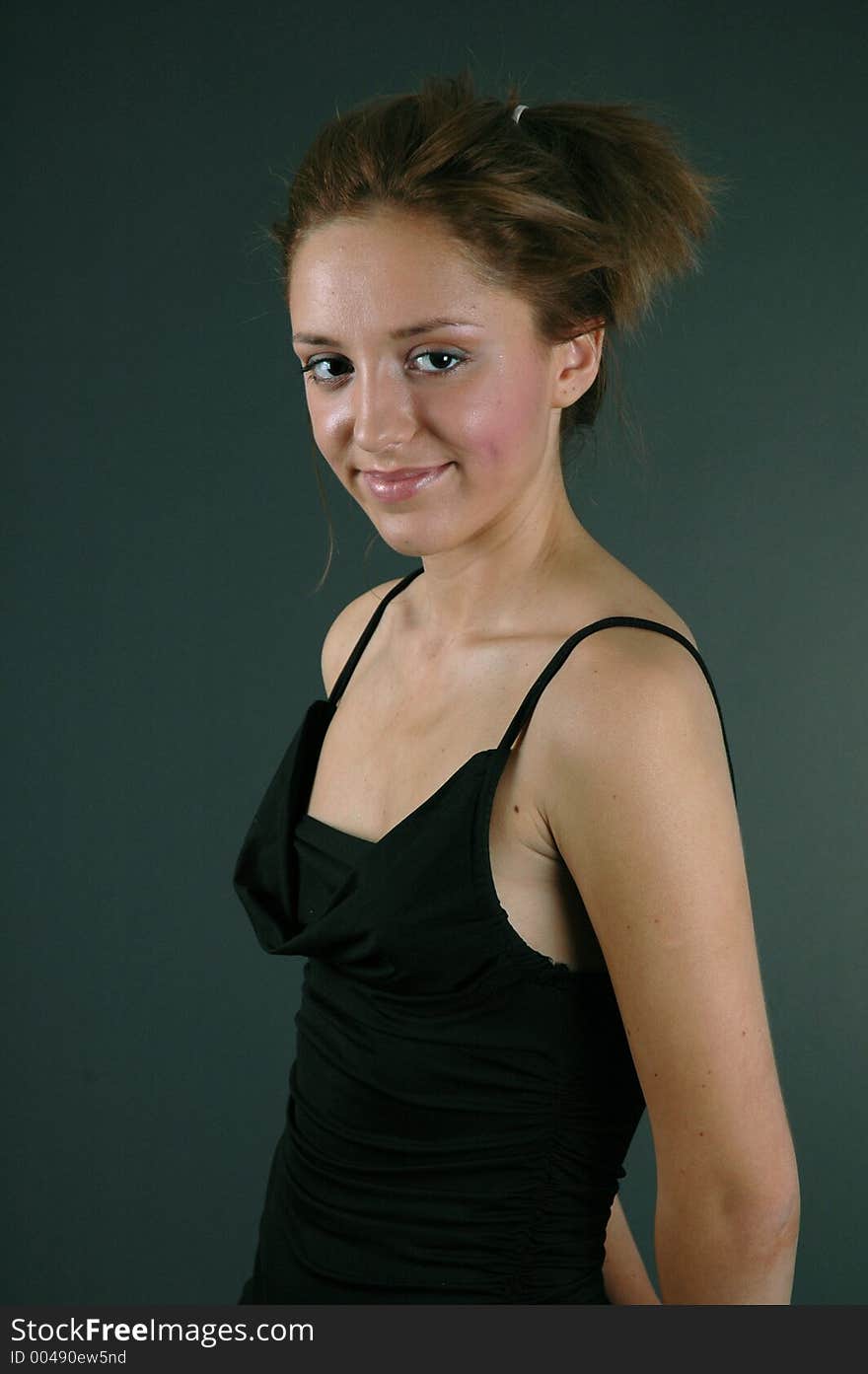 Beautiful young woman smiling in her black dress, ready to go out.