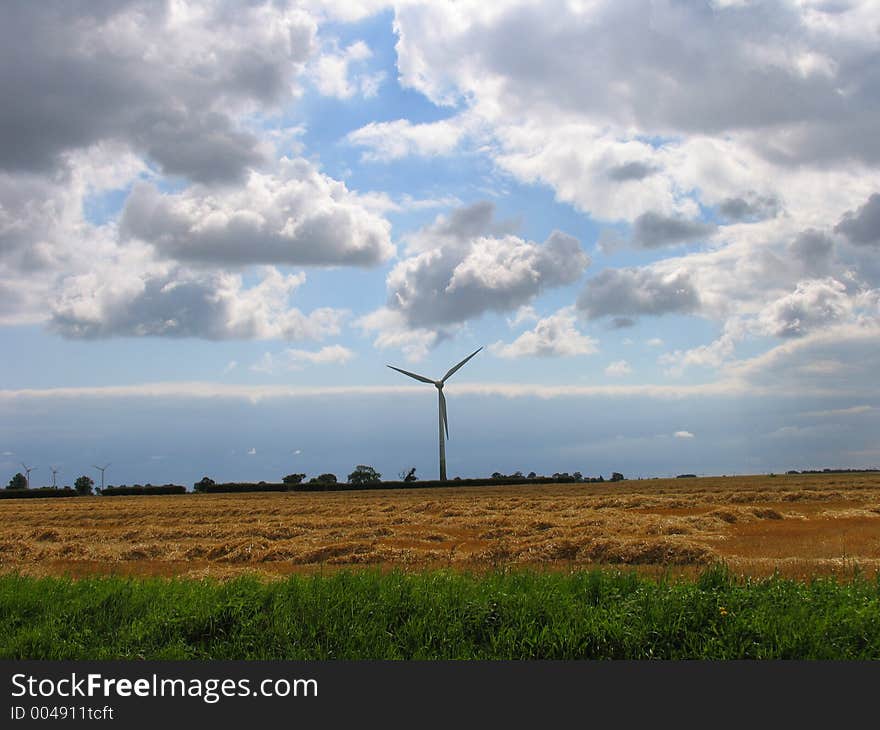 A wind turbine slowly rotates. A wind turbine slowly rotates