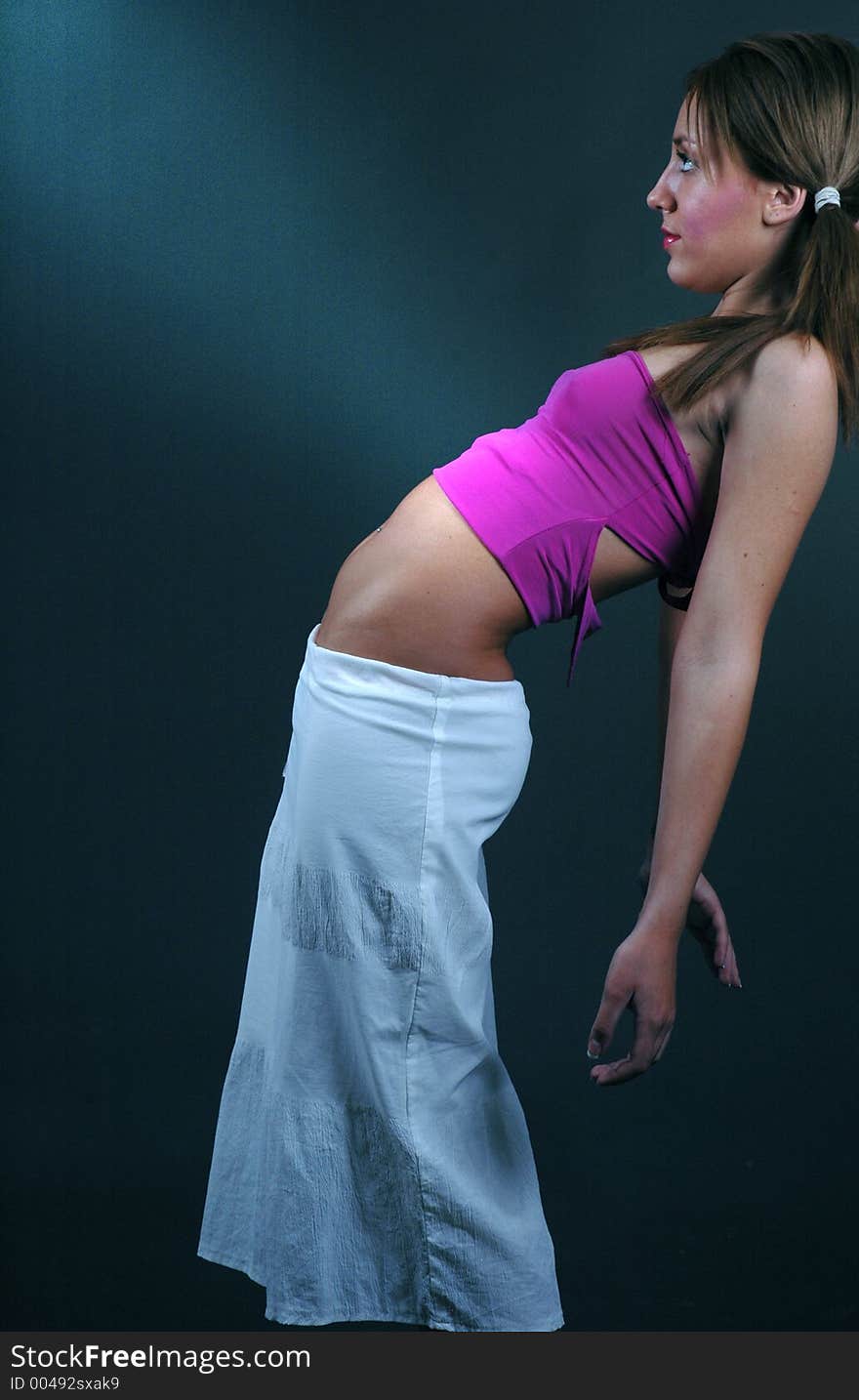 young dancer leans back on the wall highlighting her kinky pierced belly. young dancer leans back on the wall highlighting her kinky pierced belly