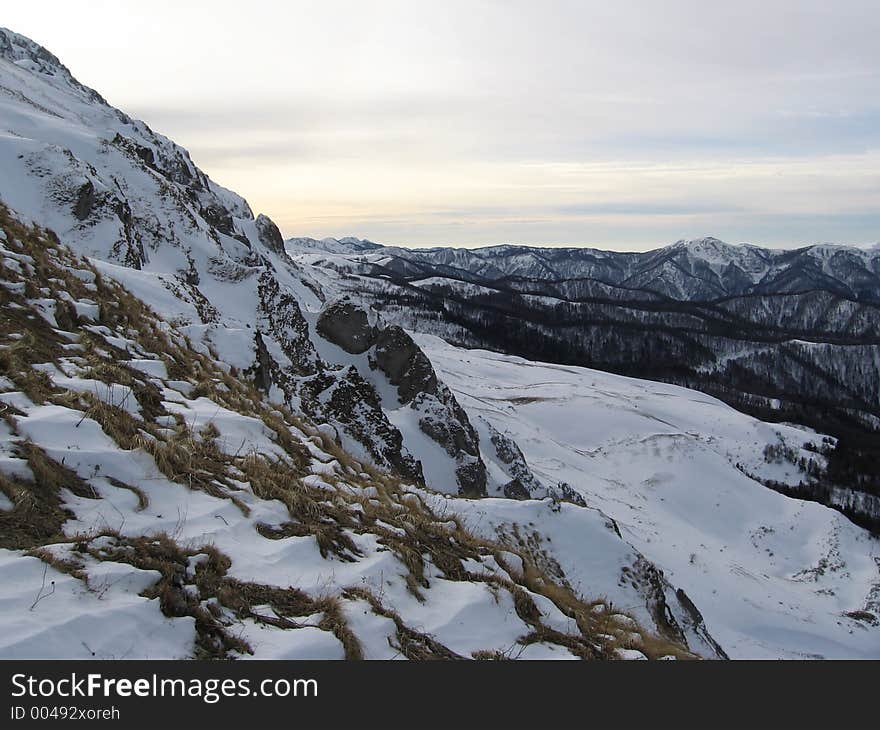 Rocks and grass under snow in the Caucasus mountains, Russia. Rocks and grass under snow in the Caucasus mountains, Russia