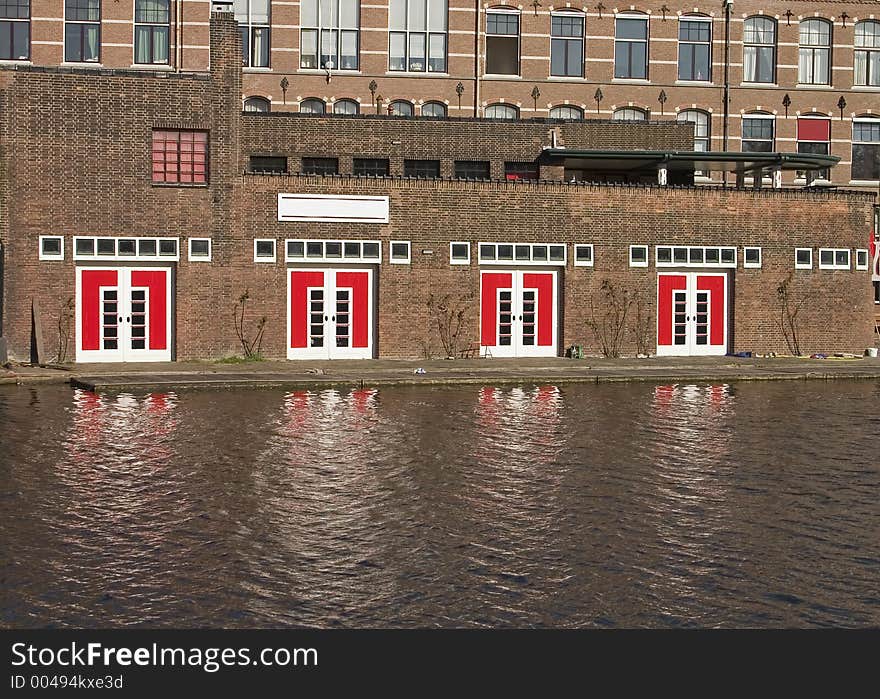 Old brick building with big bright red and white doors. Old brick building with big bright red and white doors