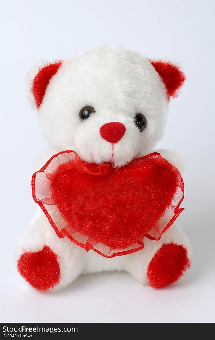 Cute white teddy bear with a red heart. Cute white teddy bear with a red heart