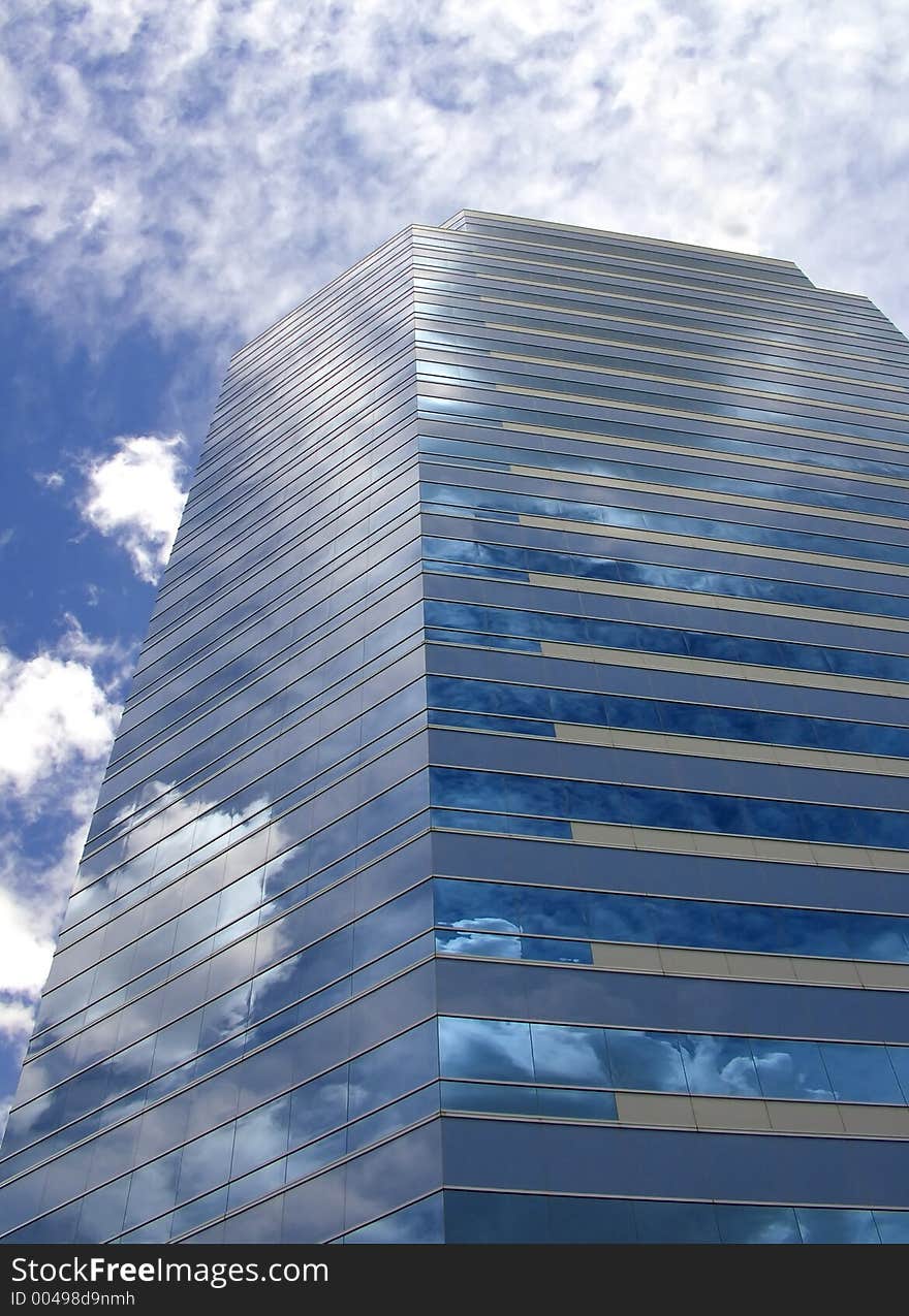 A business building reflects the sky. A business building reflects the sky.