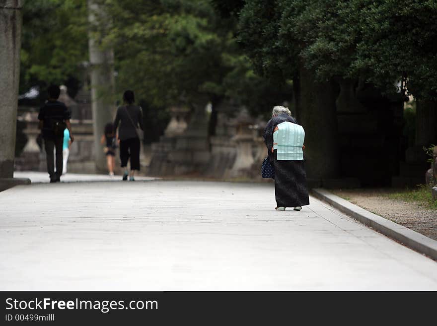 Old lady walking in the street. Old lady walking in the street