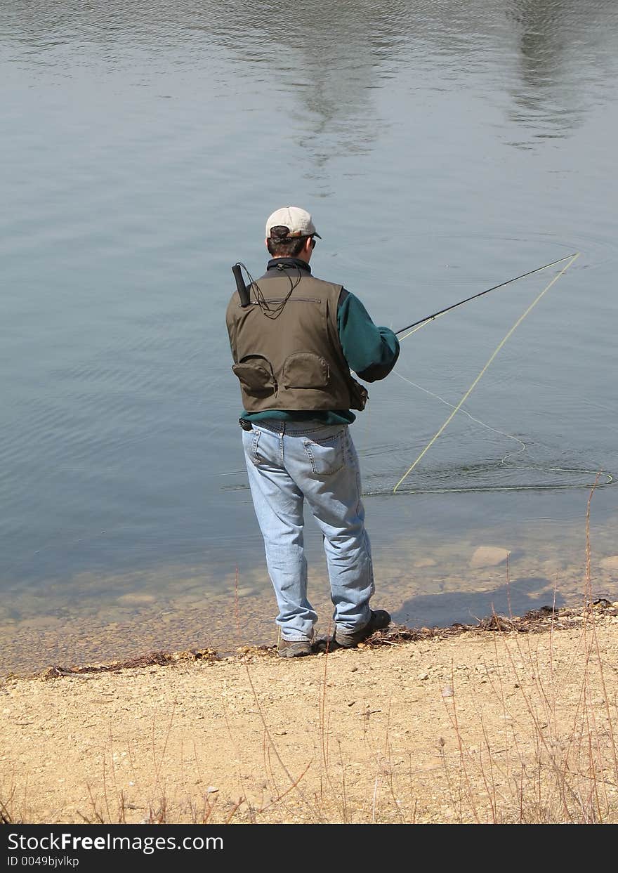 Man with fishing pole fishing. Man with fishing pole fishing