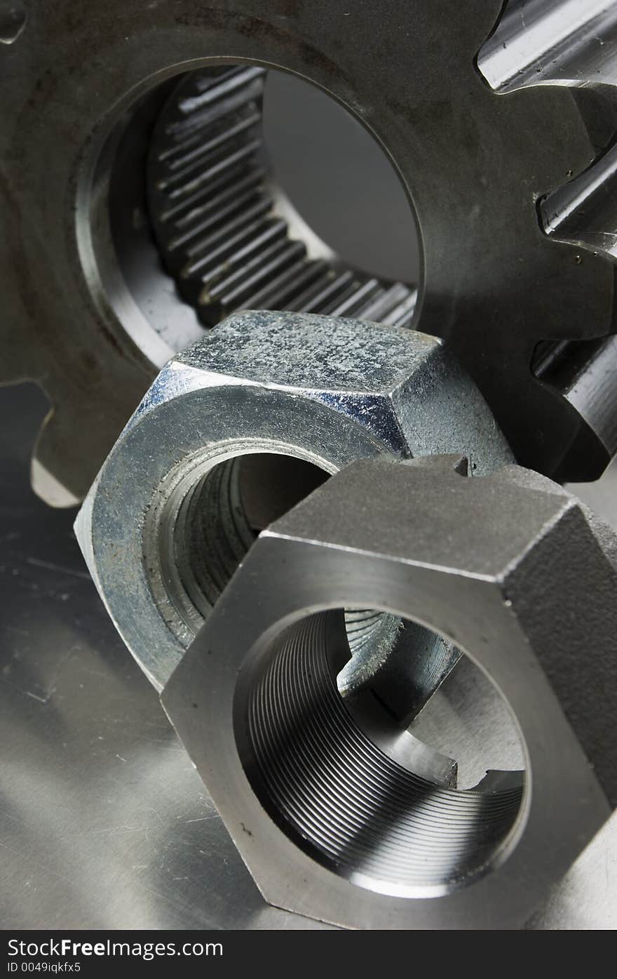 Cog and nut against brushed aluminum