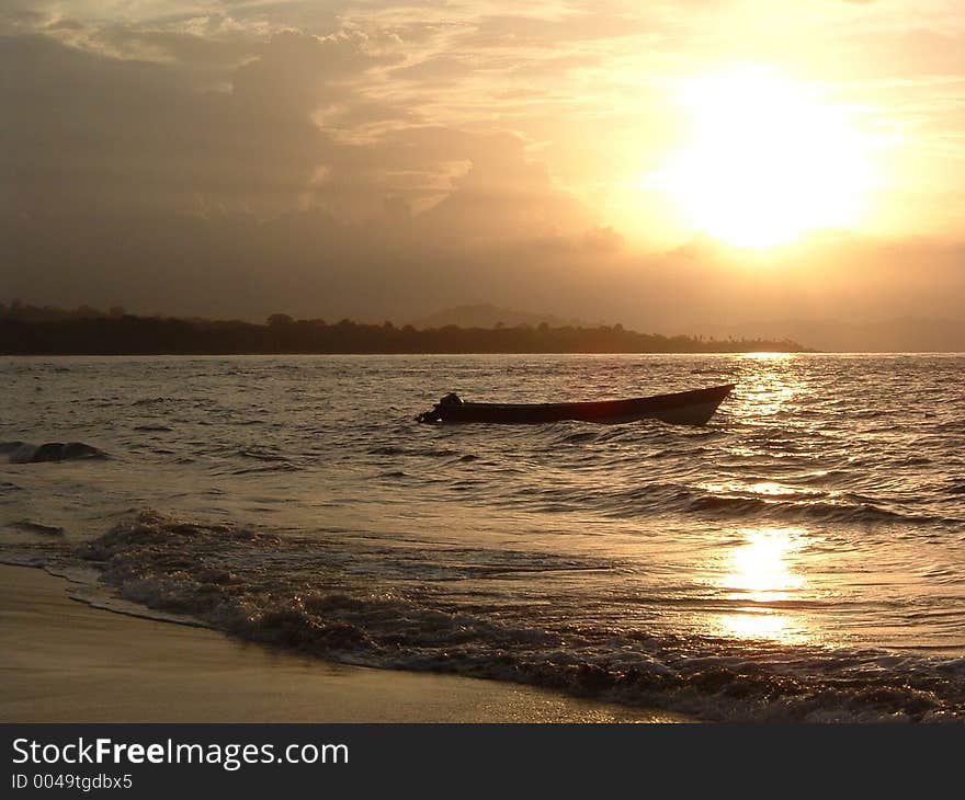 A boat remains near the beach in the tropics. A boat remains near the beach in the tropics