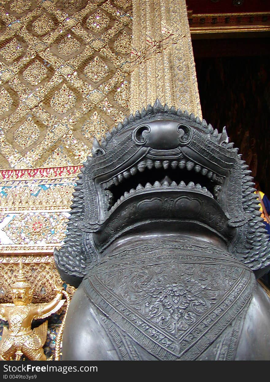 A Thai statue in front of a temple. A Thai statue in front of a temple