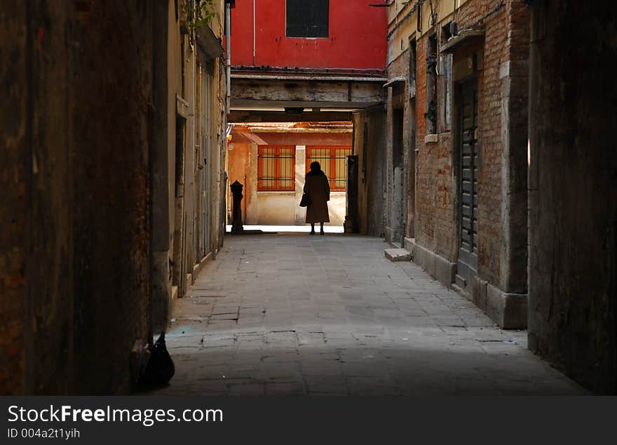 Old Womand walking through an alley in Venice (Venezia, Italy). Old Womand walking through an alley in Venice (Venezia, Italy)