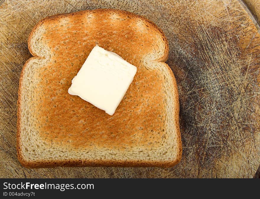 Slice of toast on old wooden board. Slice of toast on old wooden board