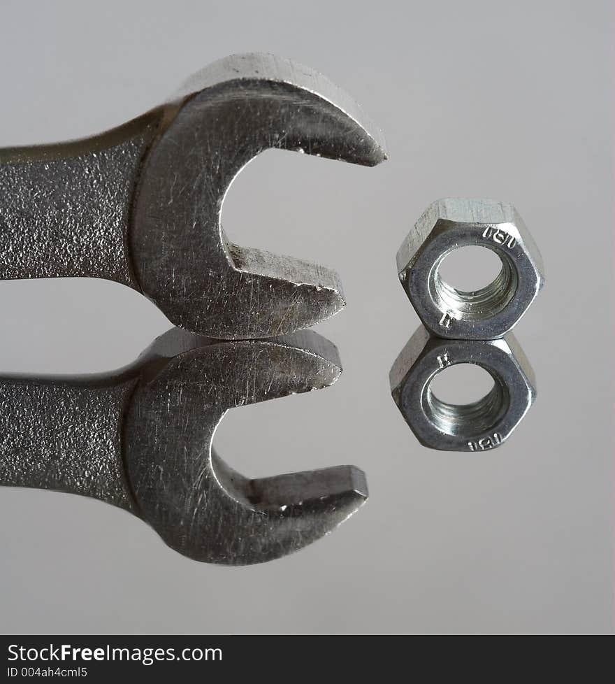 Wrench and nut, reflection