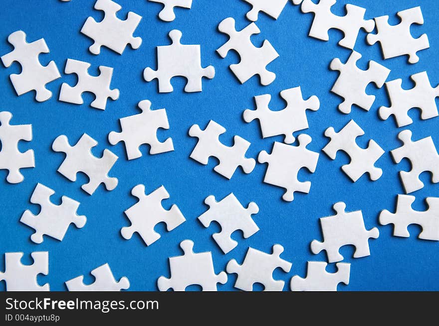 Lost puzzle pieces on blue background. Lost puzzle pieces on blue background