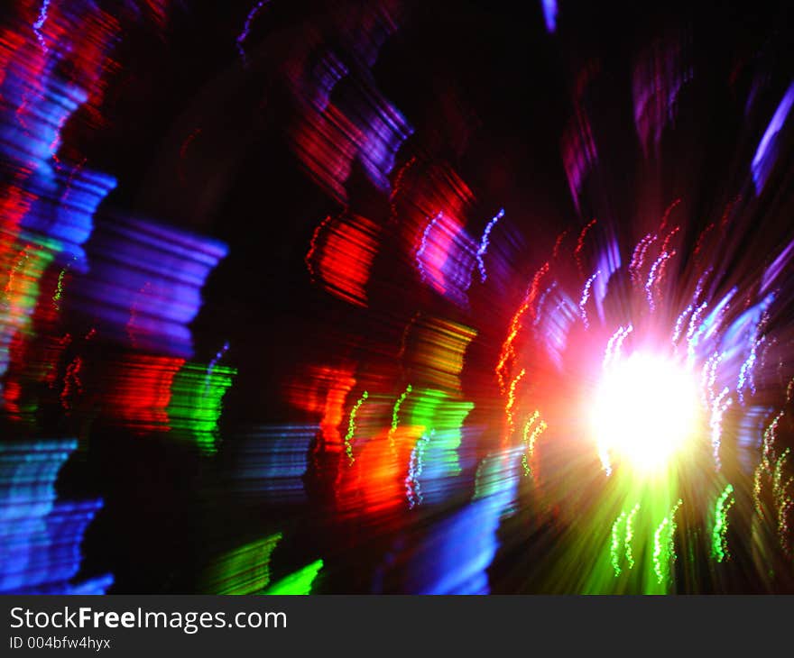 Colorful light from optical fibres vase obteind with long exposure and slow movement of fibres