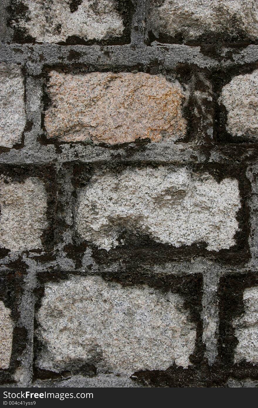 Brick wall with moss growing around it