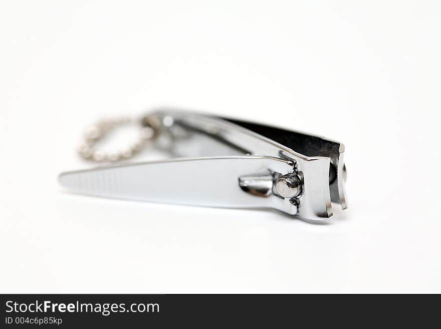 Close up shot of shiny metal nail clippers with white isolated background. Close up shot of shiny metal nail clippers with white isolated background