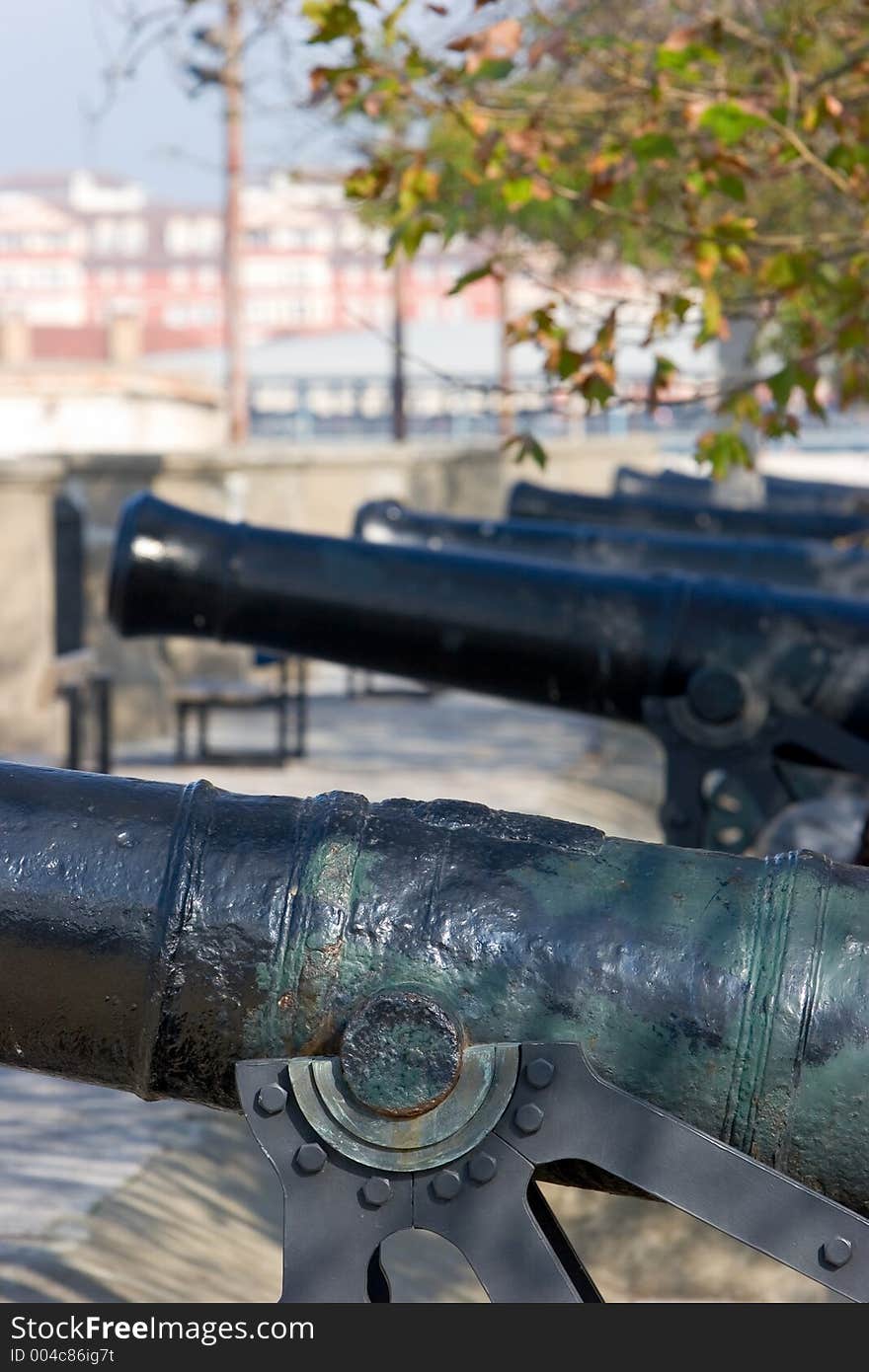 Row of original, cast iron and historical cannons in Gibraltar on a sunny day. Row of original, cast iron and historical cannons in Gibraltar on a sunny day