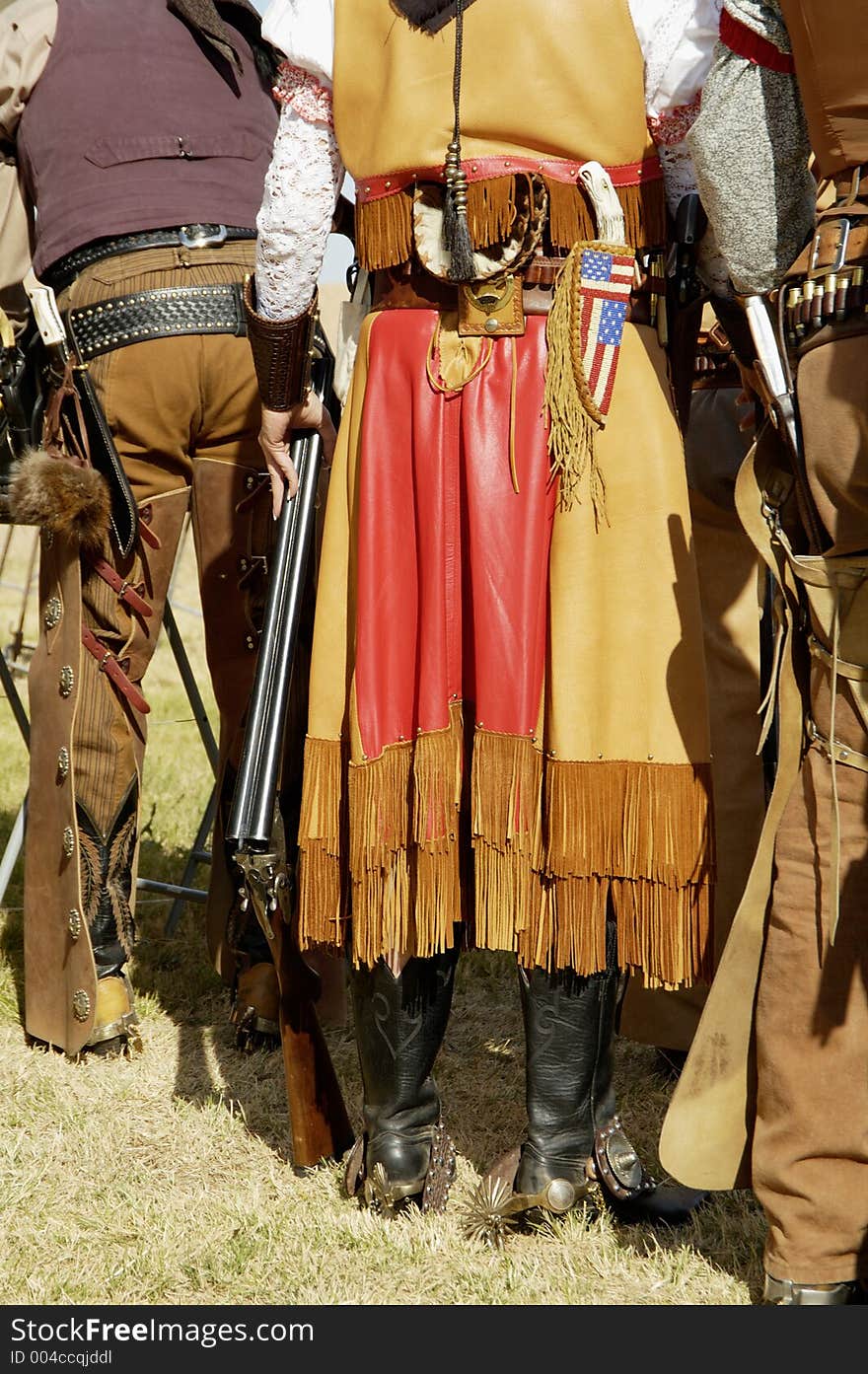 Contestants in period dress wait to compete in a cowboy action shooting event. Contestants in period dress wait to compete in a cowboy action shooting event.