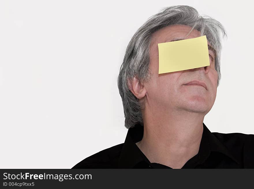 Senior with a yellow piece of paper stuck to his head. Write down whatever you want. Senior with a yellow piece of paper stuck to his head. Write down whatever you want.