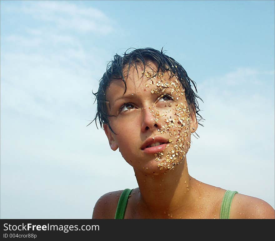 The image of the girl whose face in sand. The image of the girl whose face in sand