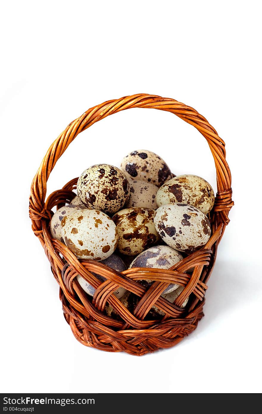 Easter quail eggs in a basket isolated on white background. Easter quail eggs in a basket isolated on white background