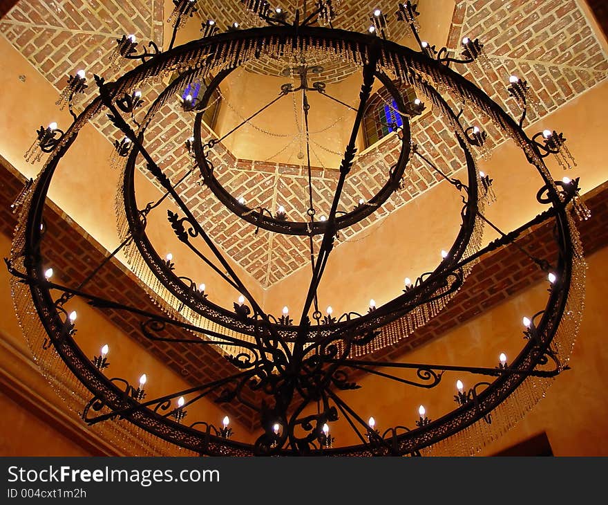 Enormous iron chandelier hanging in the foyer. Enormous iron chandelier hanging in the foyer