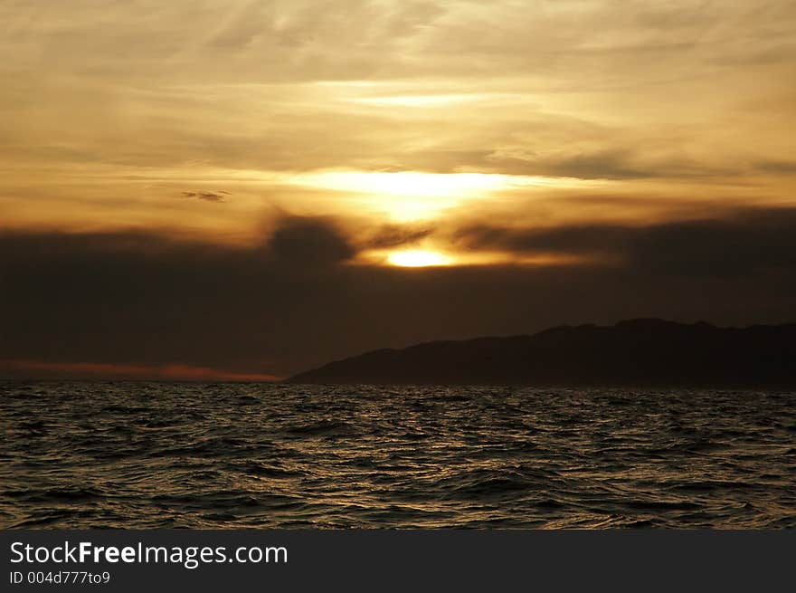 Awesome sunset coloring the ocean and the sky. Awesome sunset coloring the ocean and the sky.