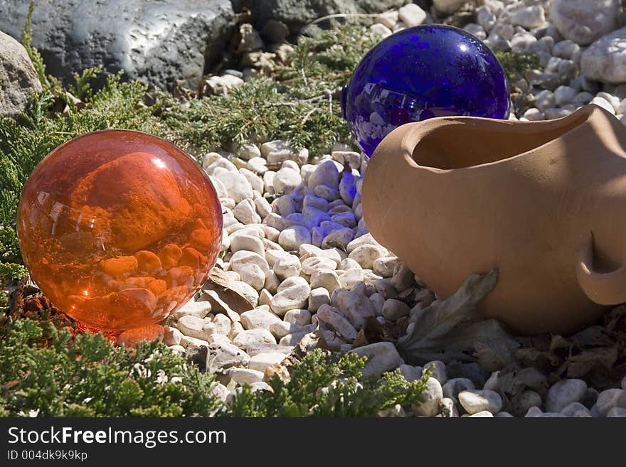 Glass balls in garden rockery.