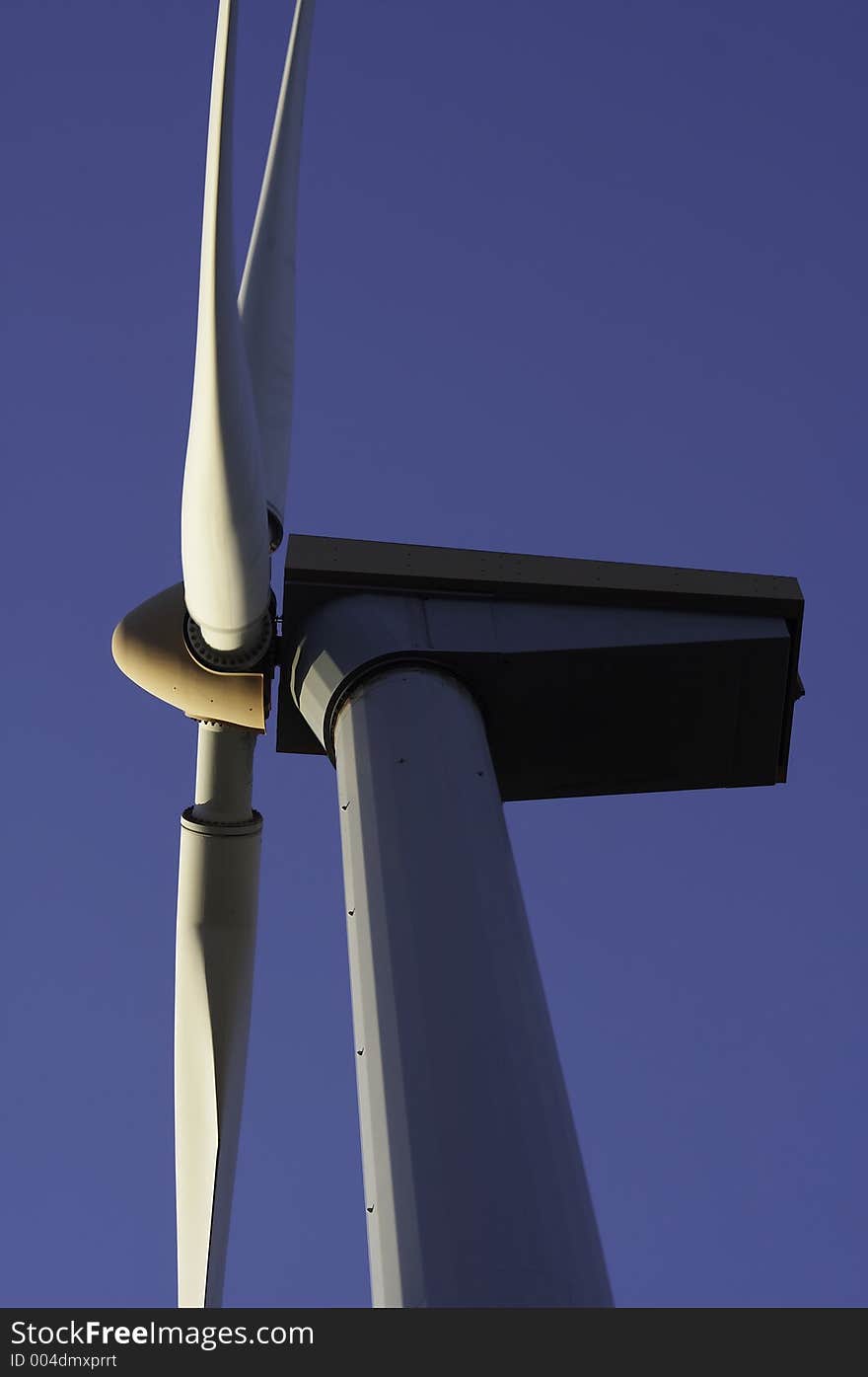 A closup of the top of a windmill, the wind turbine