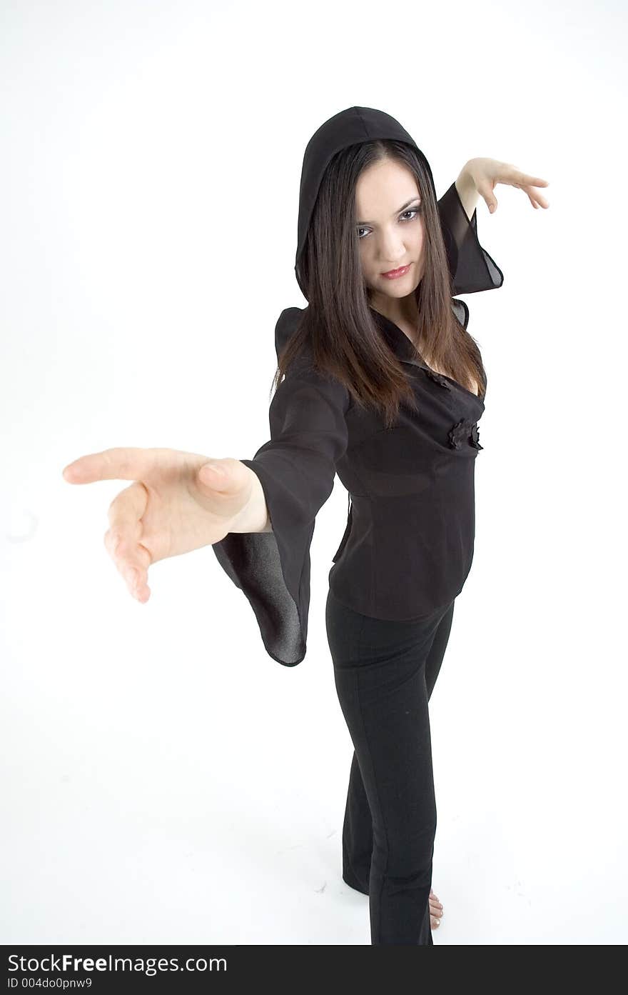 Pretty young girl dancing barefoot, dressed in a black outfit, with her hands in the air.