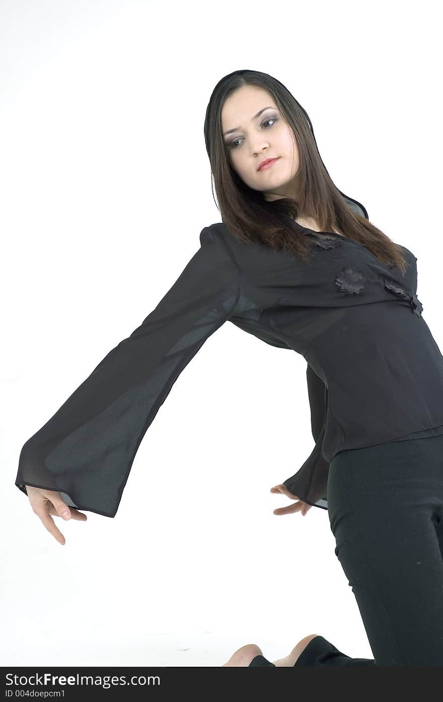 Pretty young woman dressed in a black outfit, arching back.