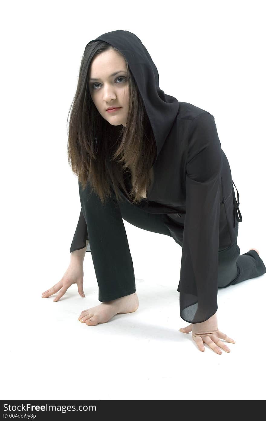 Gothic teenager girl dressed in a black outfit, practicing the moves for a modern dance. Gothic teenager girl dressed in a black outfit, practicing the moves for a modern dance.