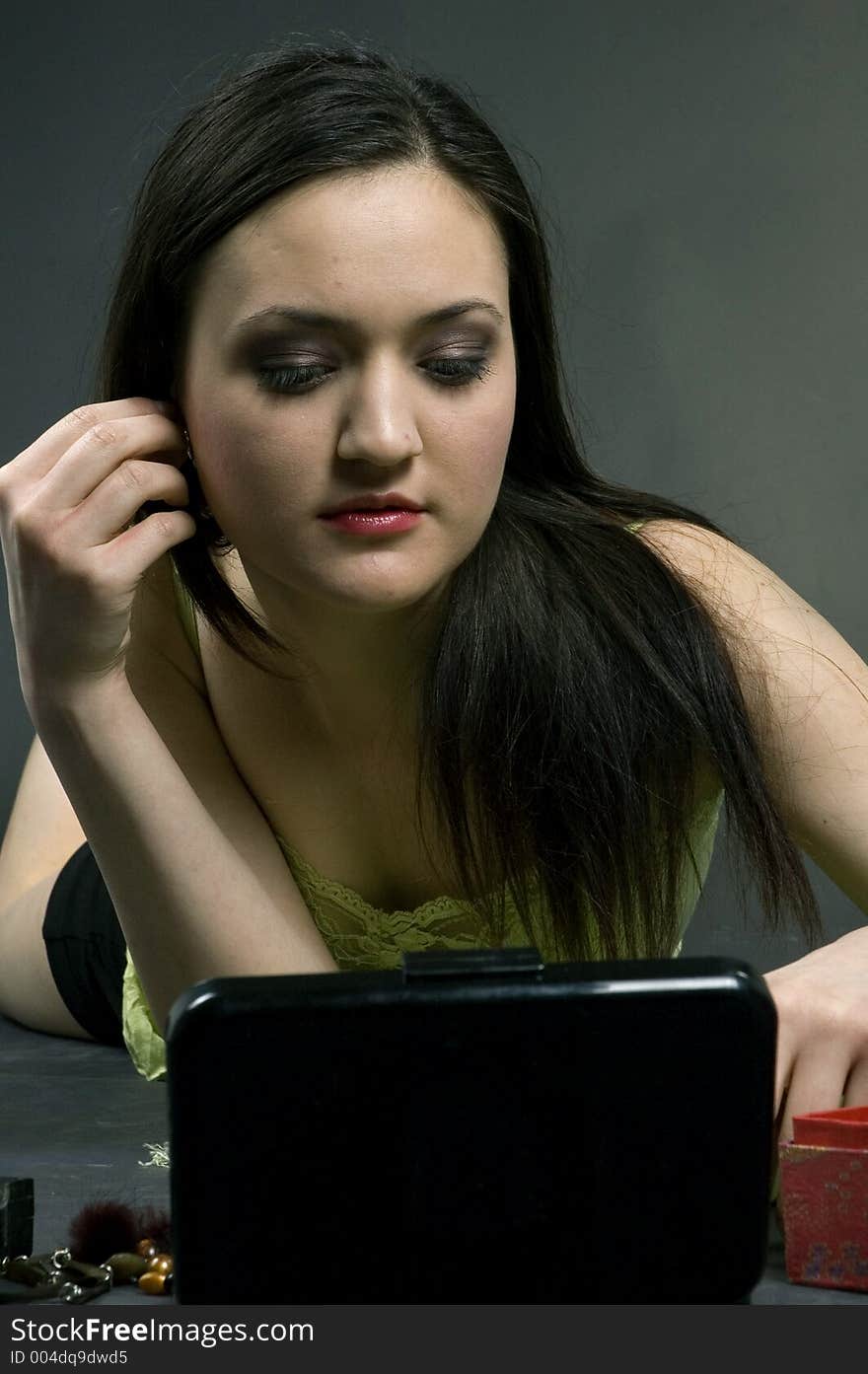 Young pretty girl arranging her hair, preparing to go out. Young pretty girl arranging her hair, preparing to go out.