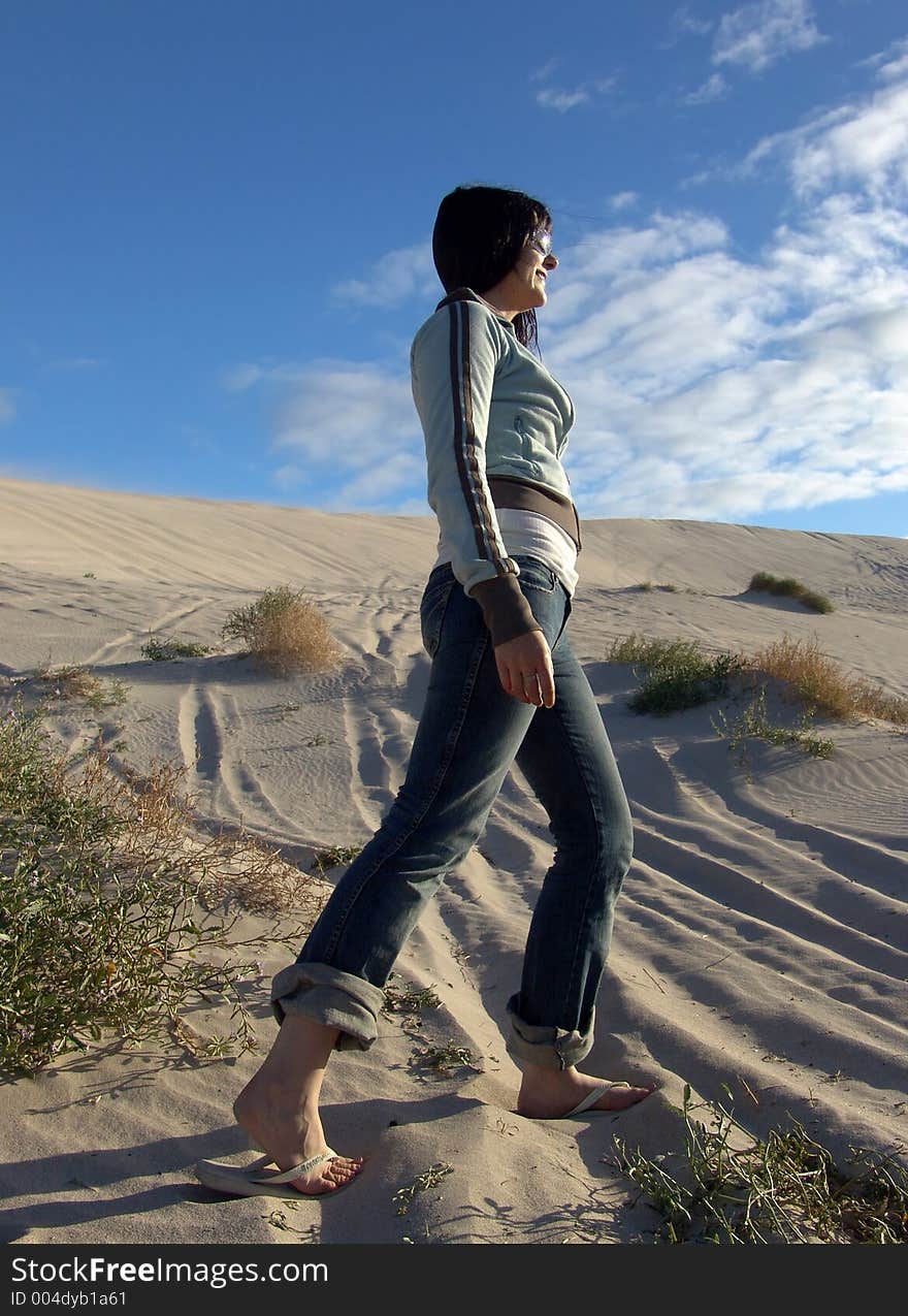 Girl Walking through Sand Dunes. Girl Walking through Sand Dunes