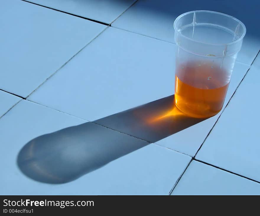 Glass with solution on the laboratory desk.....interesting lighting