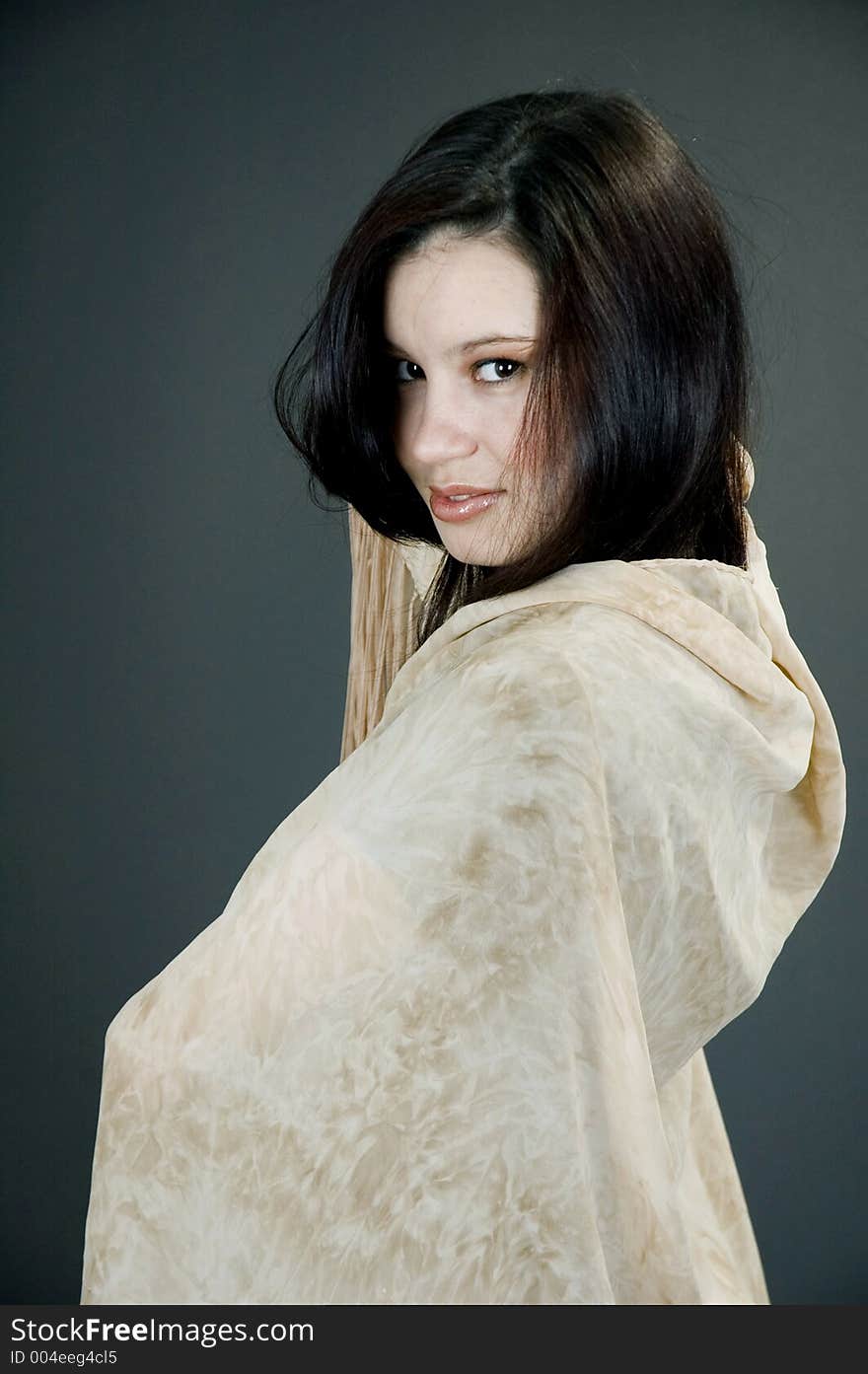 Elegant young woman with a beige scarf. Elegant young woman with a beige scarf