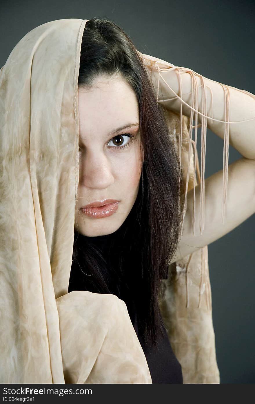 Beautiful young woman playing with a blue scarf. Beautiful young woman playing with a blue scarf